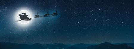 silhouette of a flying goth santa claus against the background of the christmas night sky.の写真素材
