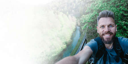 man taking a selfie in the mountains
