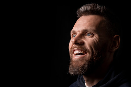 a man who marvels into the distance on a black background