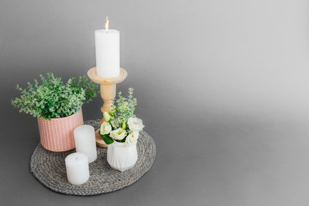 Candle holder with flowers on gray background, space for text.の写真素材