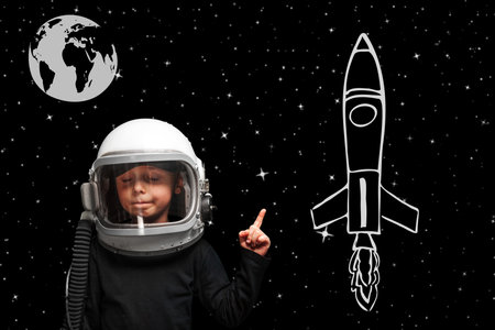 Small child wants to fly an airplane wearing an airplane helmet.の写真素材