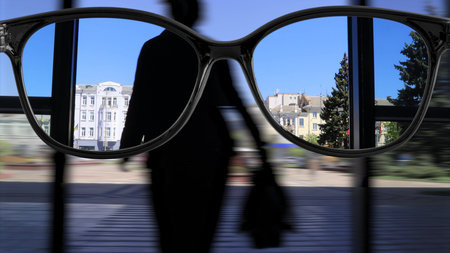 sharpness with glasses walking around the city.の写真素材
