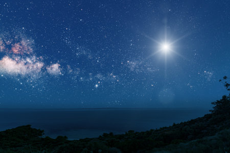 a Christmas star shines at night over the mountains of Bethlehemの写真素材