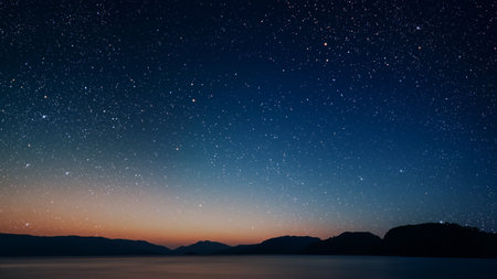 movement of stars in the night sky with the view of mountains.の写真素材