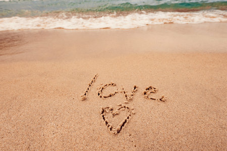 inscription love on the seashore with palm treesの写真素材