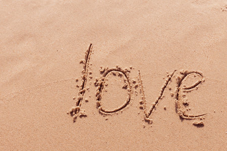 inscription love on the seashore with palm treesの写真素材