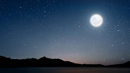 a movement of stars in the night sky with the view of mountains. . High quality photoの写真素材
