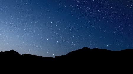 a movement of stars in the night sky with the view of mountains. . High quality photoの写真素材