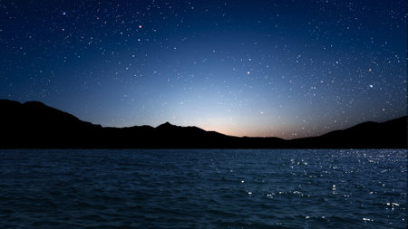 a movement of stars in the night sky with the view of mountains. . High quality photoの写真素材
