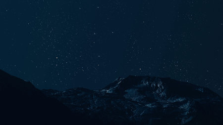 aa movement of stars in the night sky with the view of mountains.の写真素材