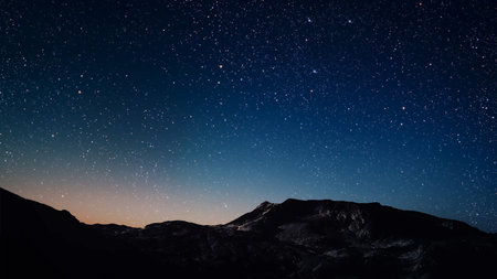 aa movement of stars in the night sky with the view of mountains.の写真素材