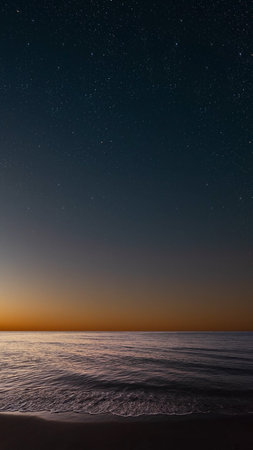 Sunrise over the sea with gentle waves and fading stars in a peacefulの写真素材