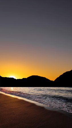 Sunrise over the sea with gentle waves and fading stars in a peacefulの写真素材