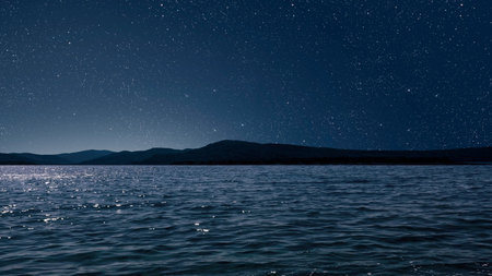 aa movement of stars in the night sky with the view of mountains.の写真素材