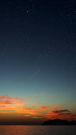 Sunrise over the sea with gentle waves and fading stars in a peacefulの写真素材