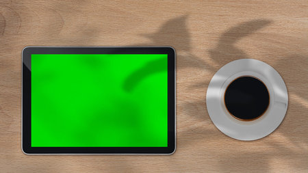 Tablet with green screen outdoors, trees swaying in the background. High quality photoの写真素材