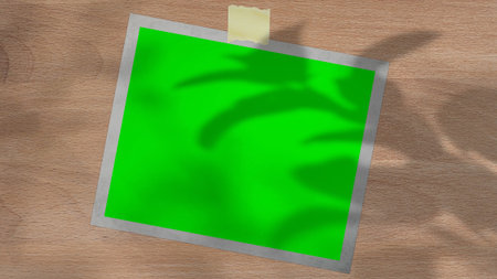 Tablet with green screen outdoors, trees swaying in the background.