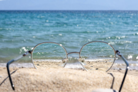 Clear sea view through glasses on a sunny beach.の写真素材