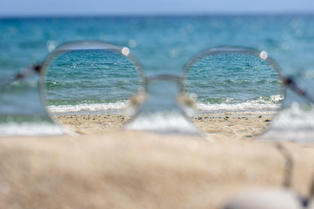 Clear sea view through glasses on a beach.