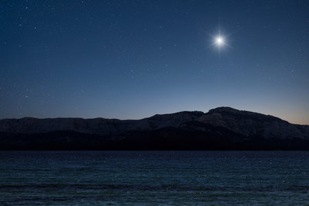 Christmas star shines at night over the mountains of Bethlehem.