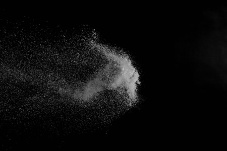 The falling white snow on a black background