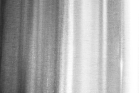 Brushed metal texture isolated on transparent background with fine scratches and industrial silver...