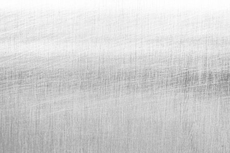 Brushed metal texture isolated on transparent background with fine scratches and industrial silver...