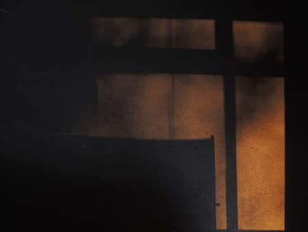 Textured background with shadows and light from the sun. Dark background. Desktop background. Black, gray, and yellow. Venetian plaster.の写真素材