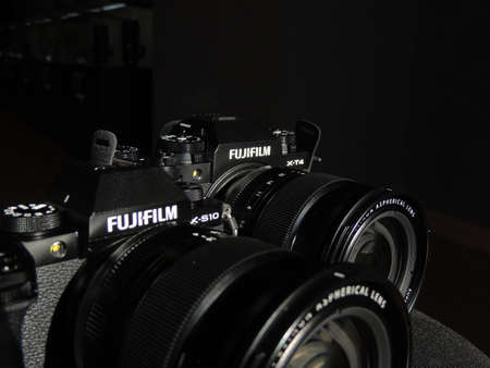Comparison of Fujifilm X-T4 and X-S10 black cameras. The best cameras for videographers. Light background. Brand.のeditorial素材