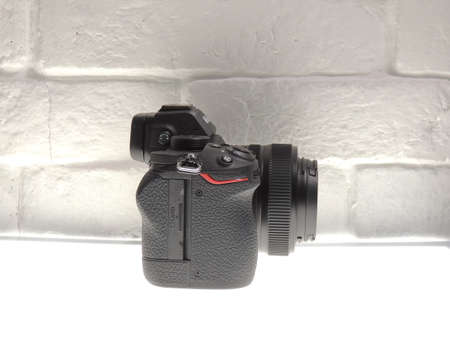 Nikon Z5 full frame mirrorless camera with 24-50mm VR lens. Light background. An entry-level...