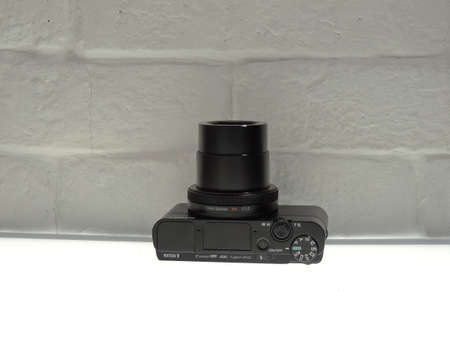 Sony Cuber-shot DSC-RX100 mark Va (rx100m5a) black, on a light white brick background.