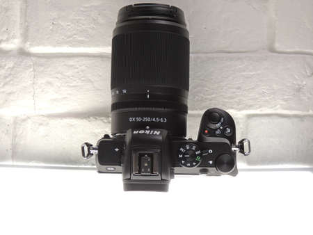 Nikon Z50 mirrorless crop camera with 50-250mm VR lens. Light background. Entry-level mirrorless...