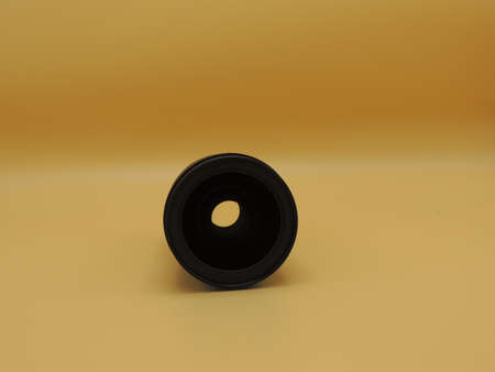 The lens is 24-70mm 2.8 on a yellow background. Macro. A camera lens.の写真素材