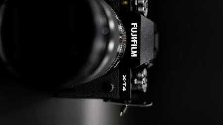 Fujifilm X-T4 kit 16-80 mm black. The best mirrorless camera. On a dark background.のeditorial素材