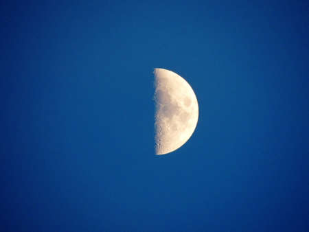 The moon on a blue background (sky). Macro photography with a zoom lens.の写真素材
