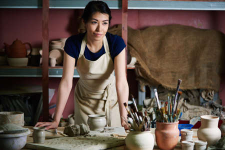 Charming pottery artist working in studio