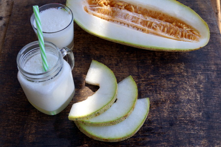 Smoothies of melon, slices of melon on the table, yogurt. The concept of healthy eating. Veganism, vegetarianism.の写真素材