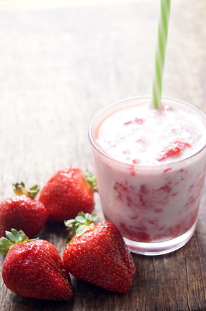 Fresh strawberry cocktail milkshake on a wooden background. Healthy food for breakfast and snacks.の写真素材