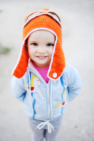 baby girl in pilot hat smiling at the camera.dream of flyingの写真素材