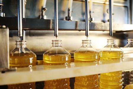 Sunflower oil production plant. Bottling line of vegetable oil in bottlesの写真素材