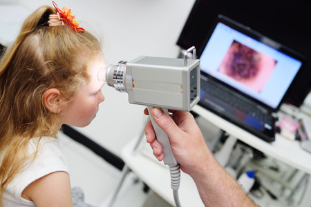 the doctor examines the special medical device moles child