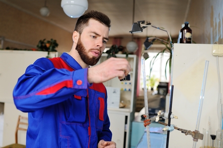 A young scientist conducts chemical experiments in the laboratoryの写真素材
