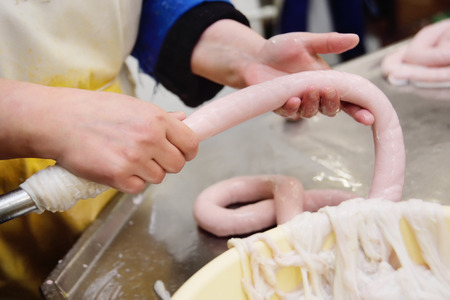 food production of sausage at a meat-packing plant. Butchers process meatの写真素材