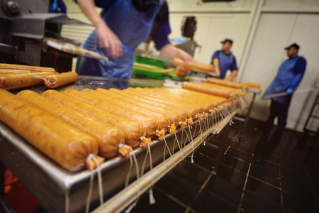 production of boiled sausages and smoked sausage at a meat factory. Food industryの写真素材