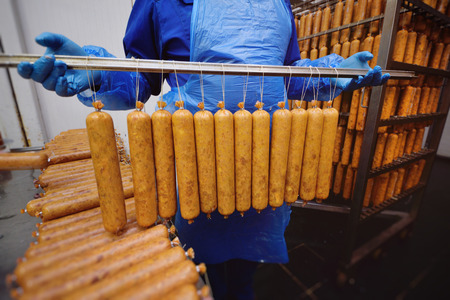 Smoked sausage in the oven. Sausage production in the factory.
