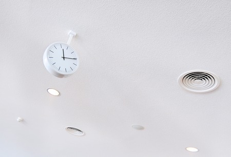 white clock on white futuristic background close-upの写真素材