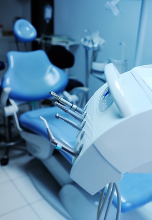 Modern dental equipment close up on a background of blue dental chairの写真素材