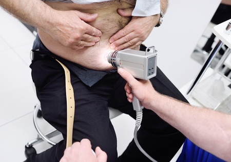 The dermatologist examines the moles or acne of the patient with a dermatoscope. Prevention of...
