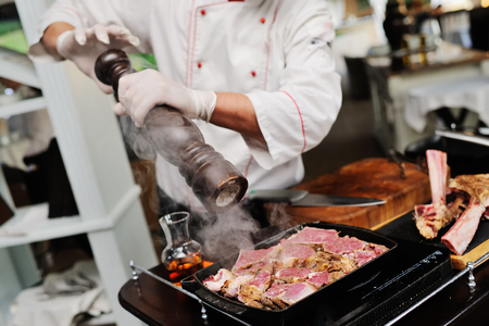 the chef holds a master class for cooking meat for the guests of the restaurantの写真素材