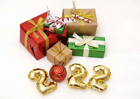 inscription 2022 of golden numbers on the background of Christmas gifts and Christmas toys.